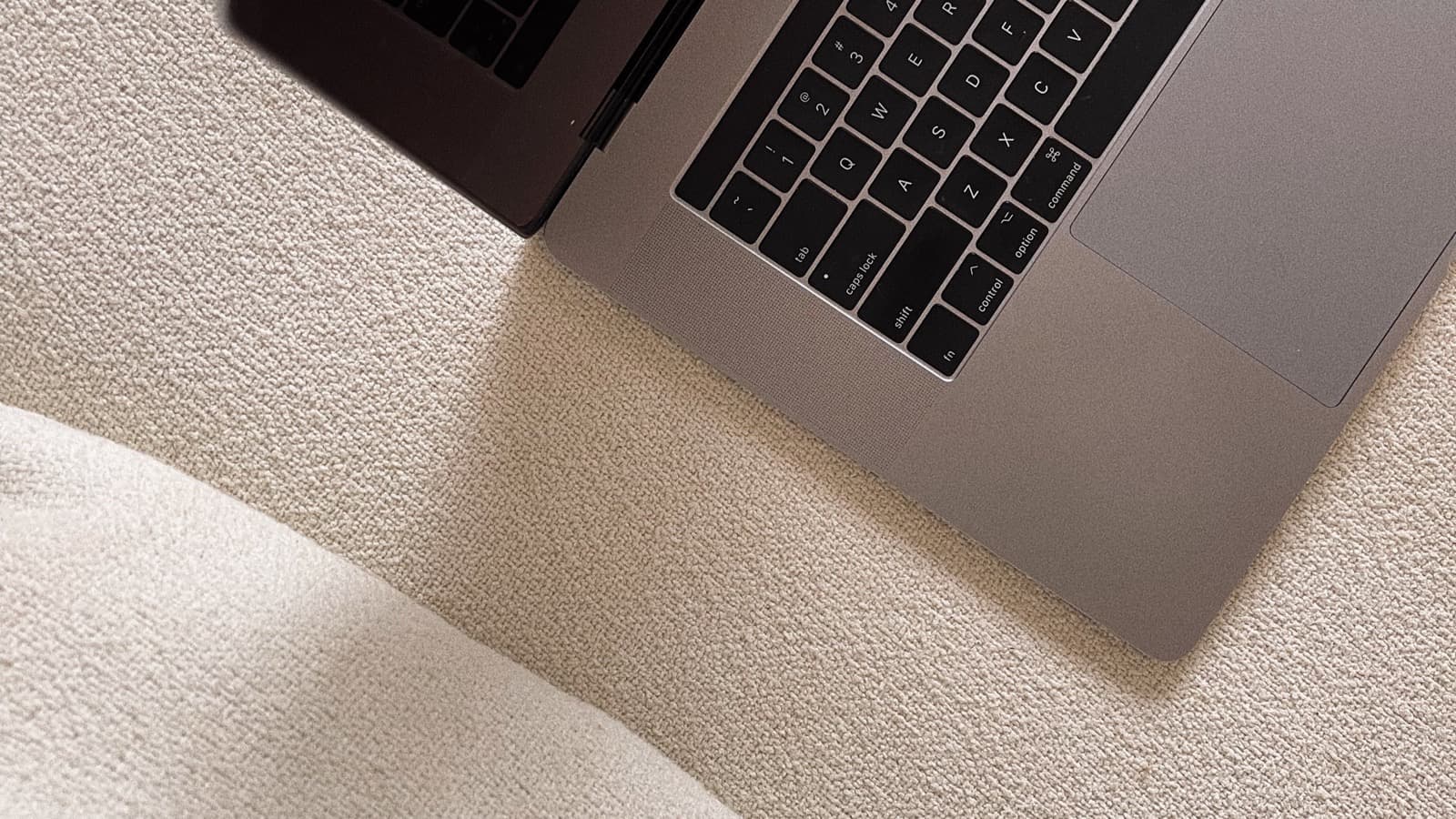 A laptop on a desk with a coffee cup, representing an automated creator workflow