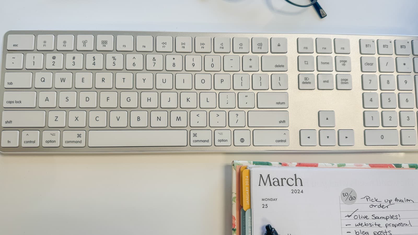 Open planner and notebook on a desk ready for planning a month of content