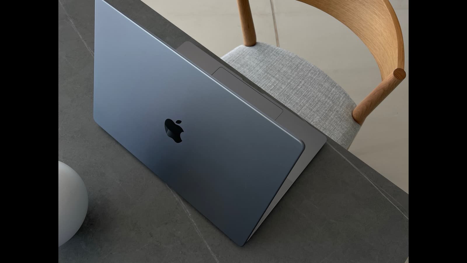 Open laptop and notebook on a desk in a bright creative workspace