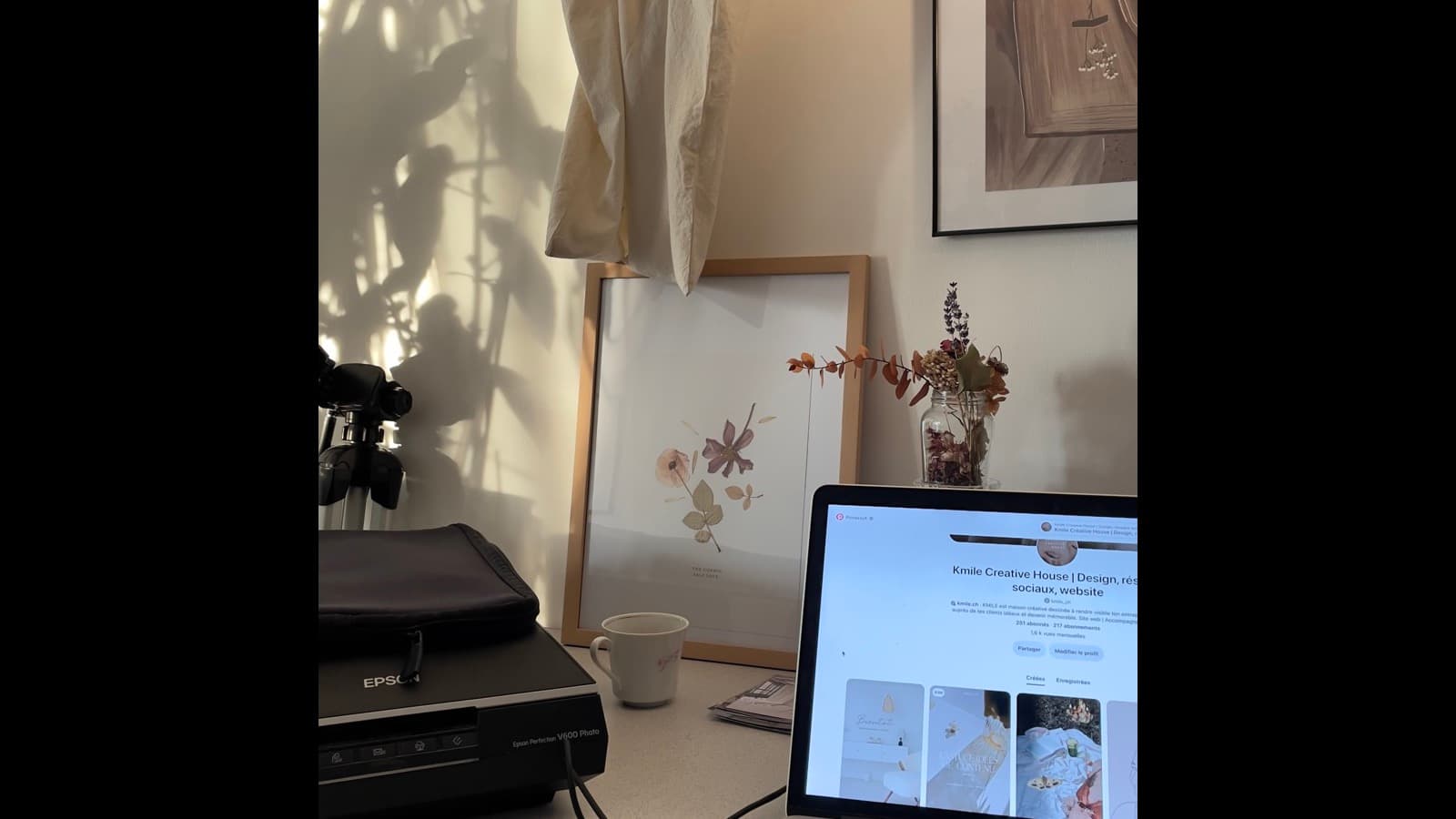 Creative workspace with a laptop and dried flowers, representing a digital products shop