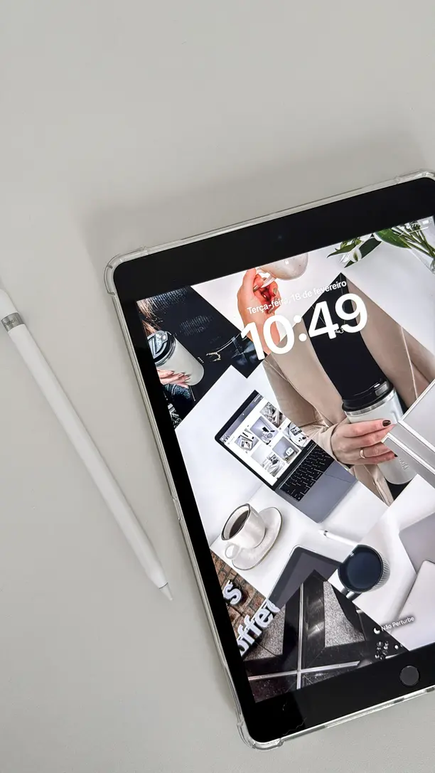 A smartphone displaying Instagram analytics with revenue charts beside a notebook
