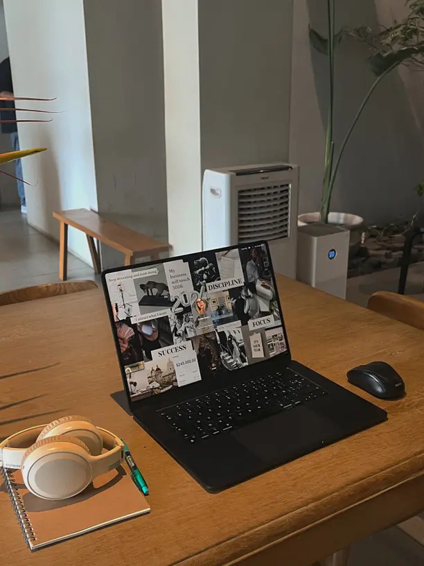 Smartphone on tripod recording a creator at a desk
