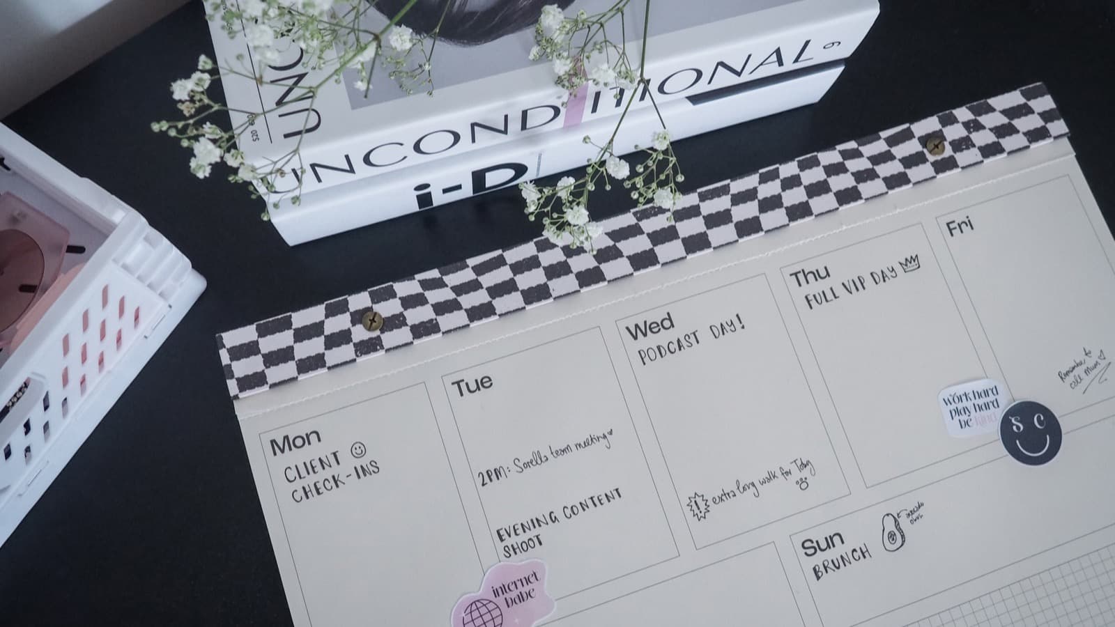 An open planner and calendar on a desk, representing consistent content planning