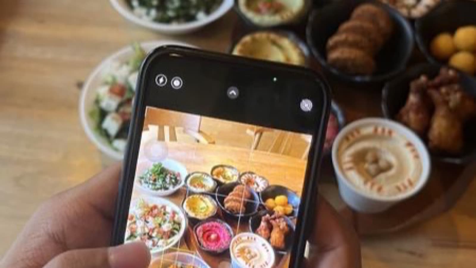 Hand holding a smartphone with Instagram open, showing a chat with a creator channel