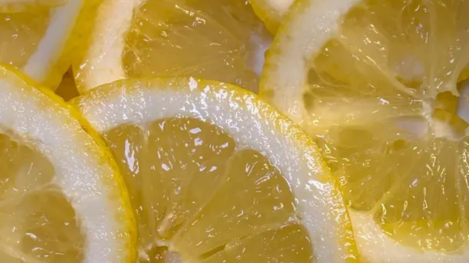 A bright yellow lemon on a warm pastel background