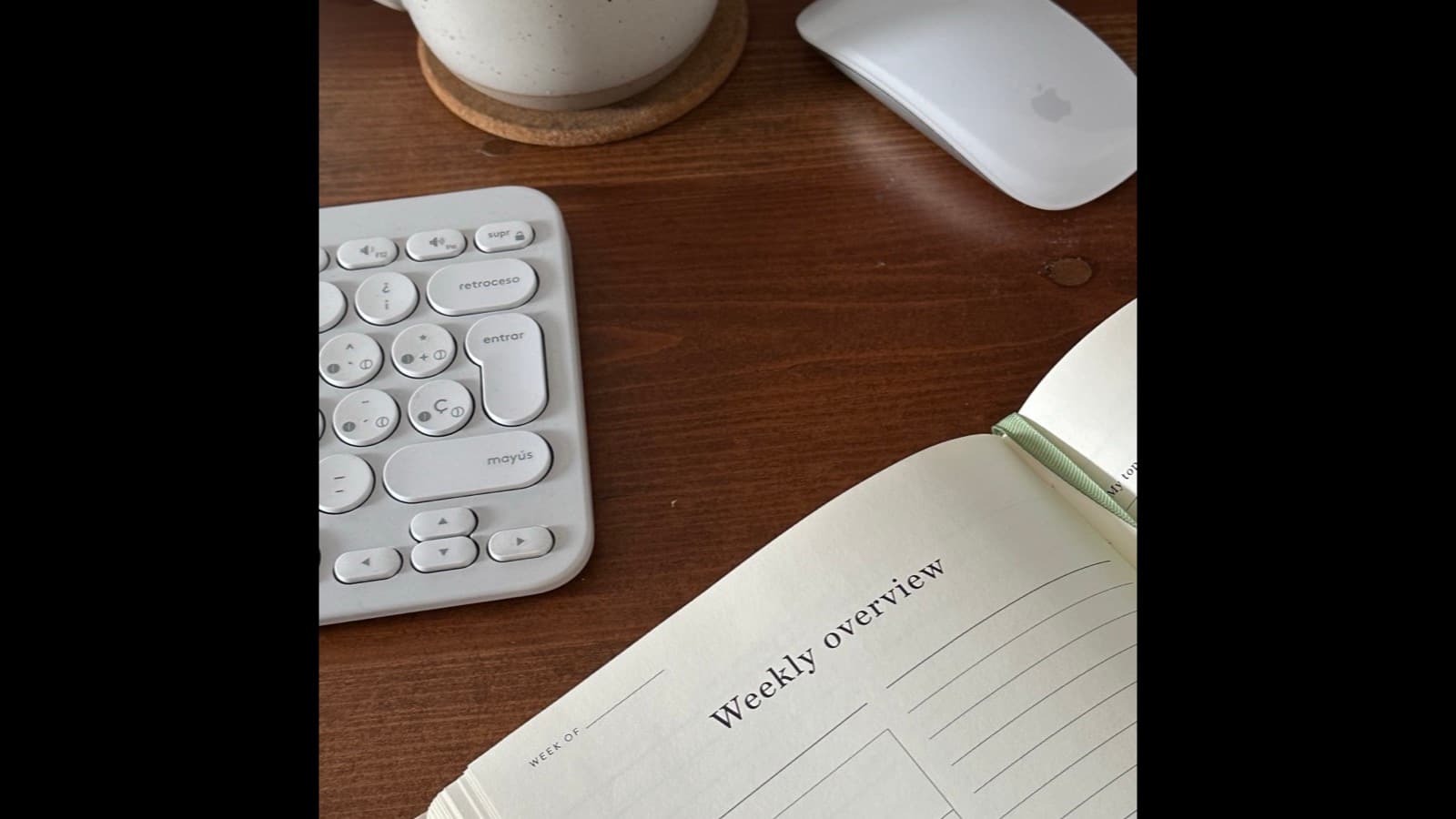 Organized desk setup with a planner and work-from-home essentials, representing a content workflow system