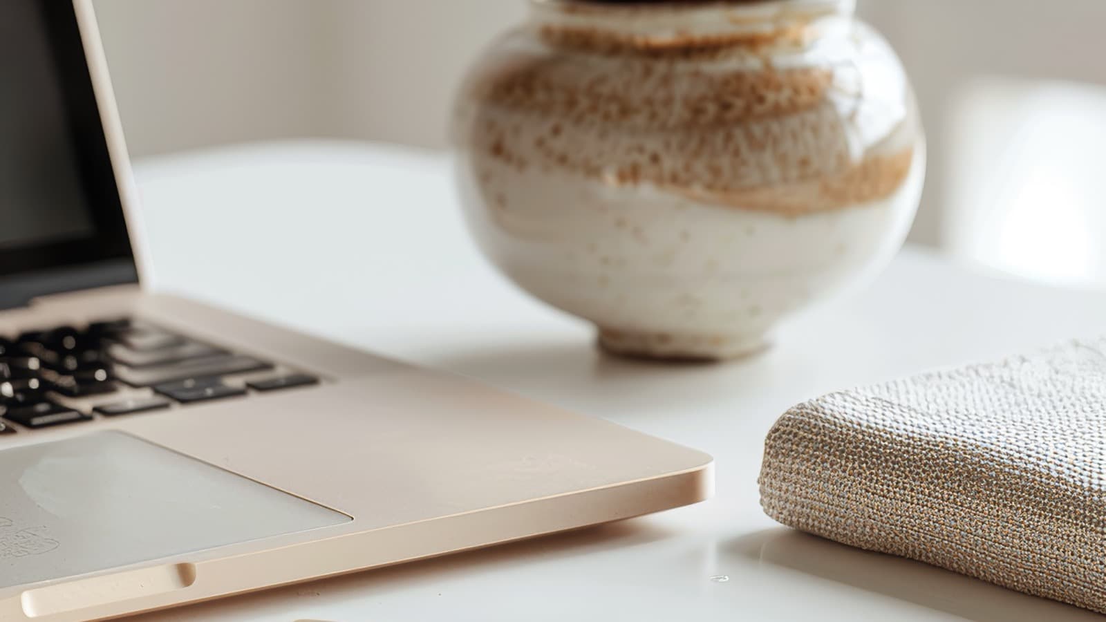 Laptop and notebook on a desk, representing weekly trend research