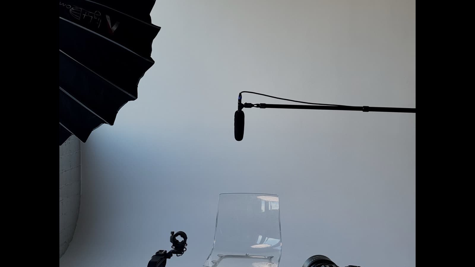 Content creator filming with camera and microphone in a studio setup