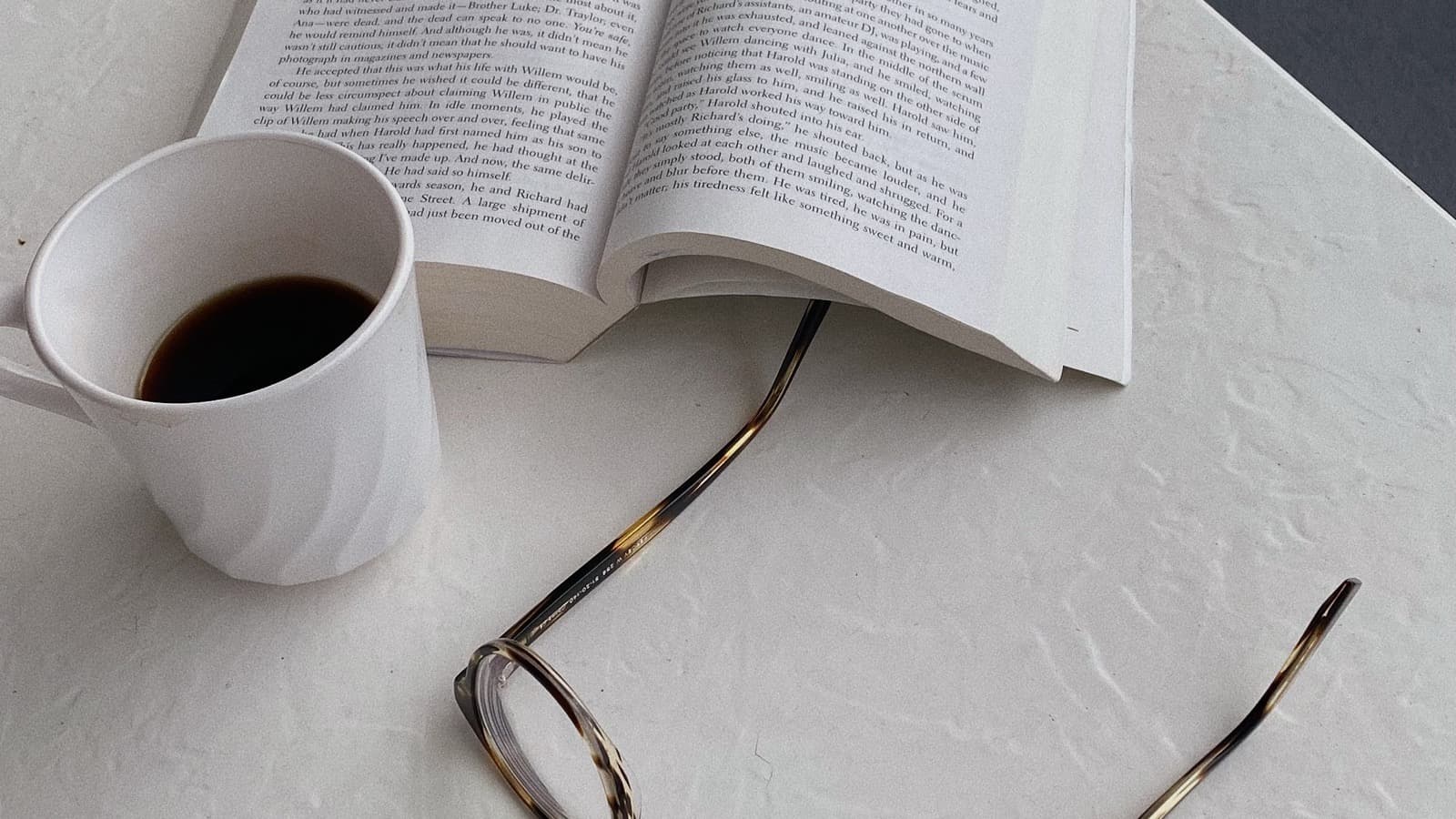 Glasses resting on an open book, representing learning and starting something new later in life