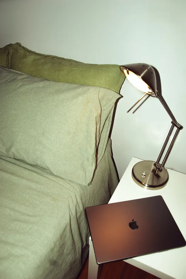 A desk with creator equipment including a camera, microphone, ring light, and laptop