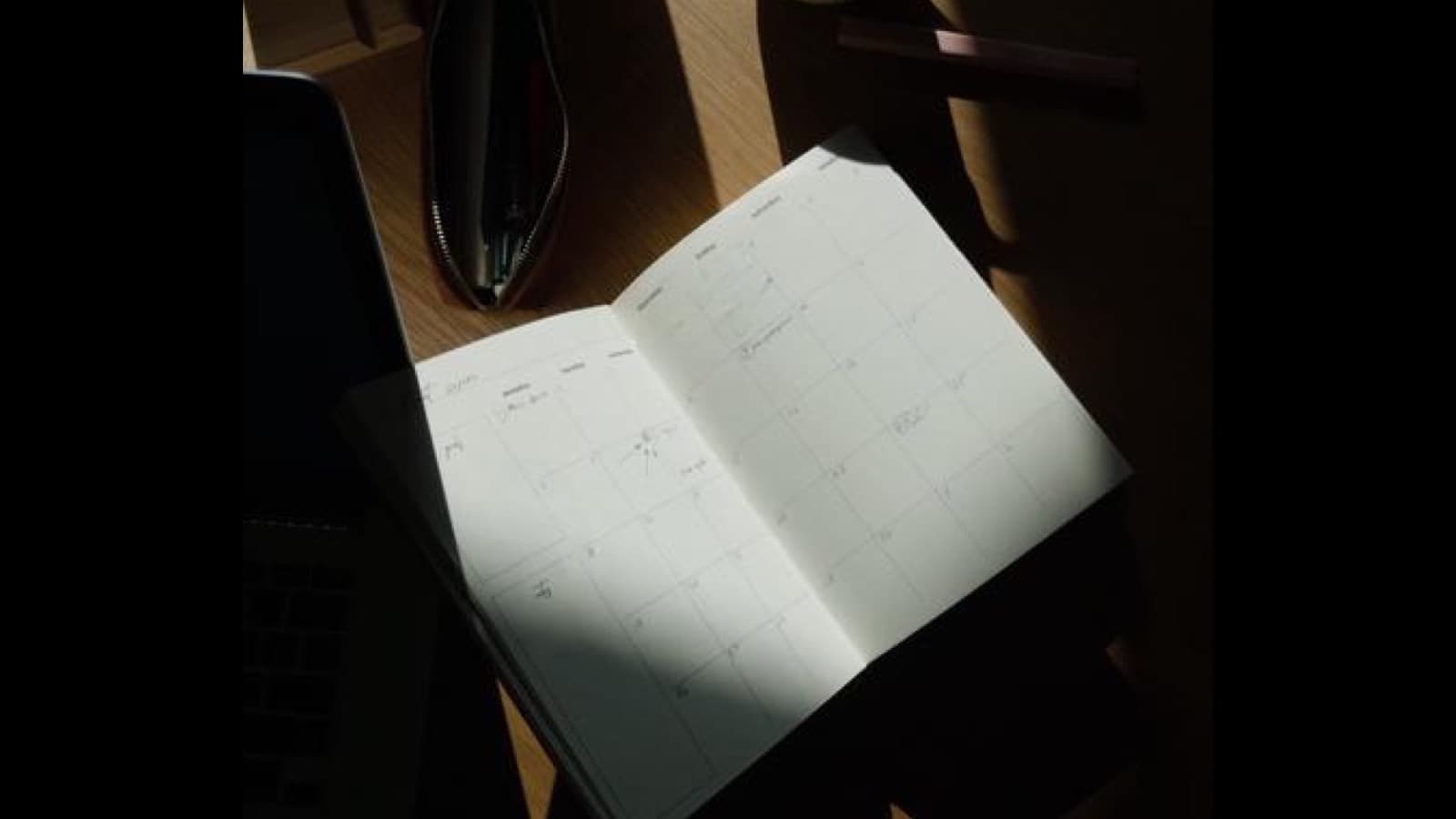 Open notebook with handwritten notes and a pen, symbolizing drafting and letting go of perfect