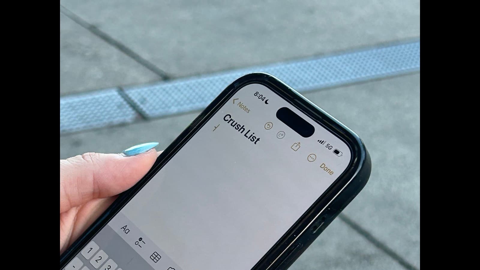 A creator sitting alone with a phone, scrolling through social media at night