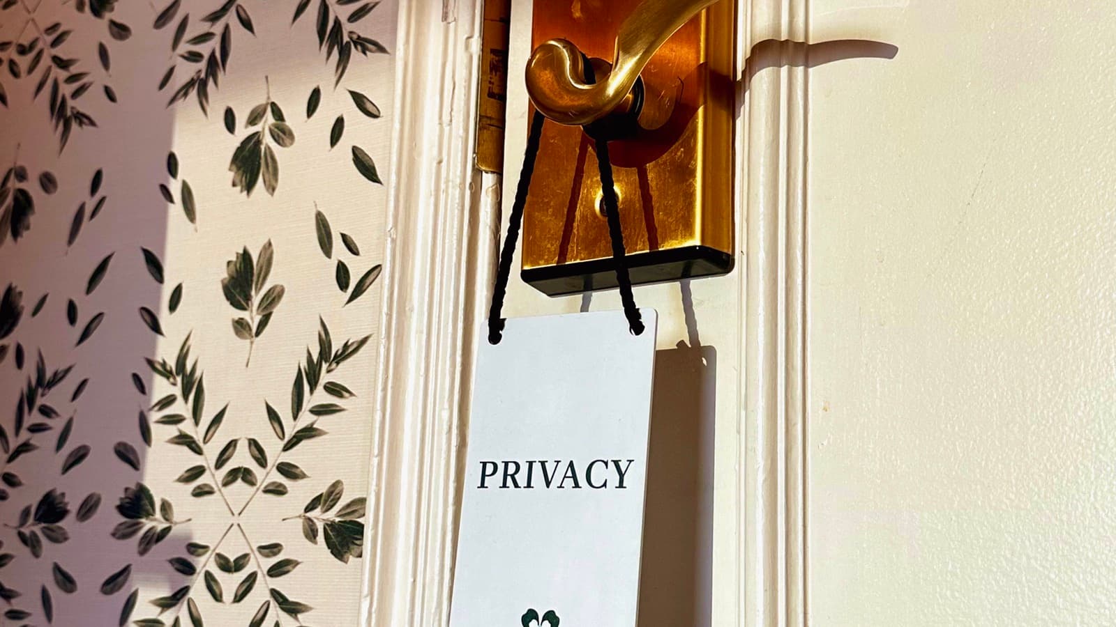 A phone, keys, and a notebook on a table, representing personal privacy and home security