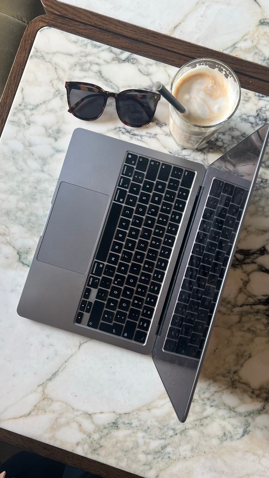 Creator editing a video timeline on a laptop with caption text visible on the screen