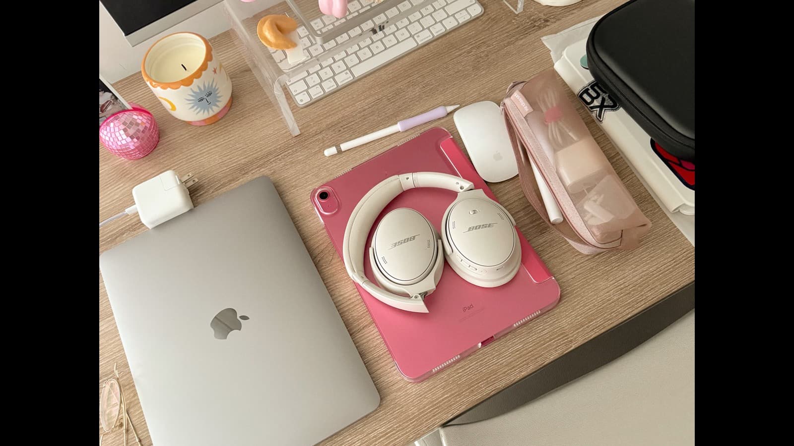 Creator working at a desk with a laptop, notebooks, and coffee