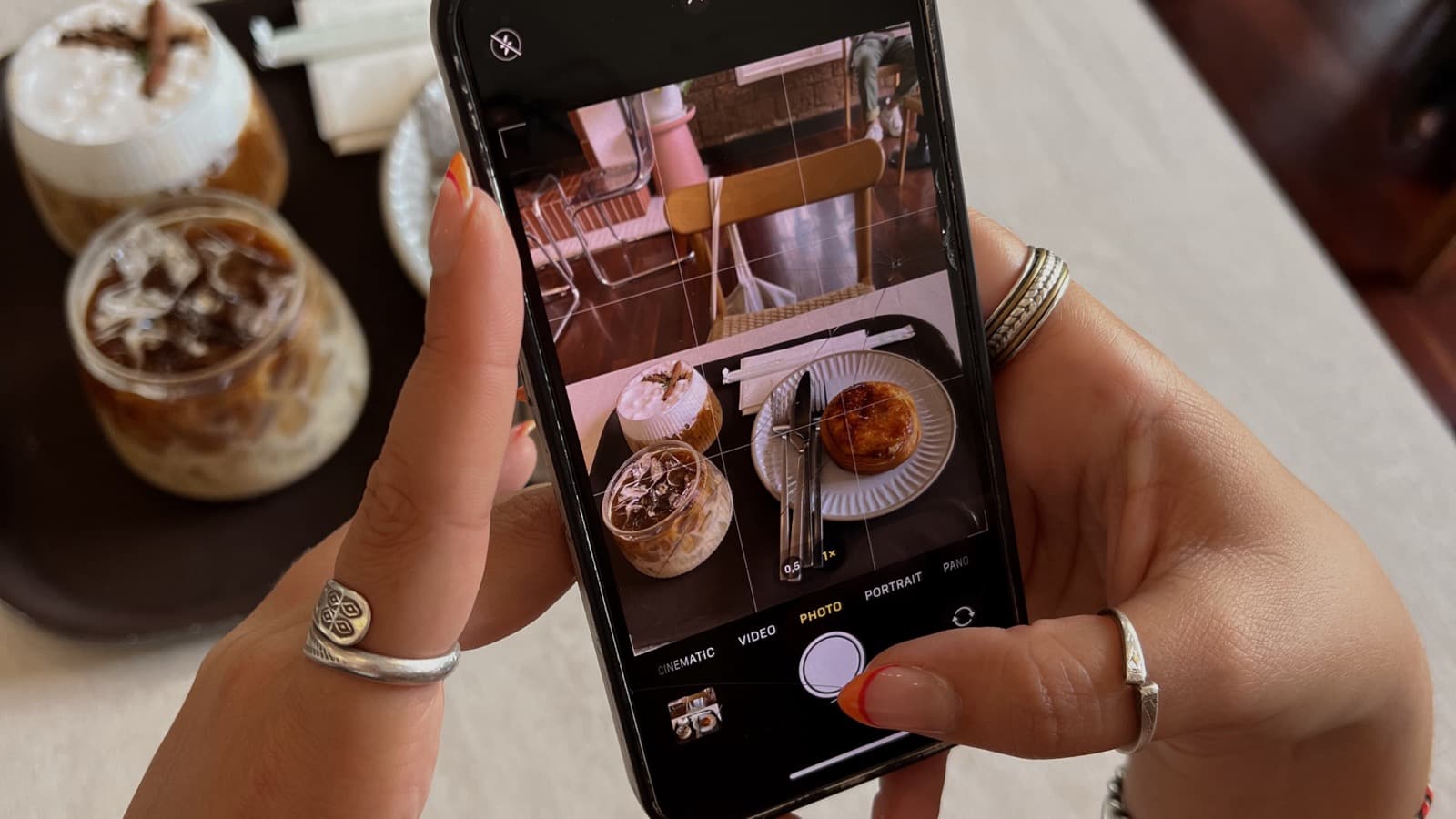 Person holding a smartphone, representing Instagram collaboration features